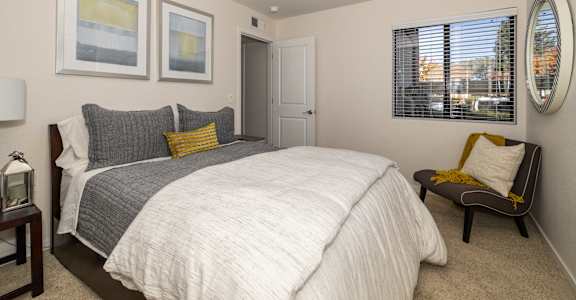 a bedroom with a large bed and a window at Rocklin Manor  Apartments, Rocklin  , CA 95677
