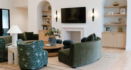 A living room with a fireplace, a sofa, a chair, and a coffee table.