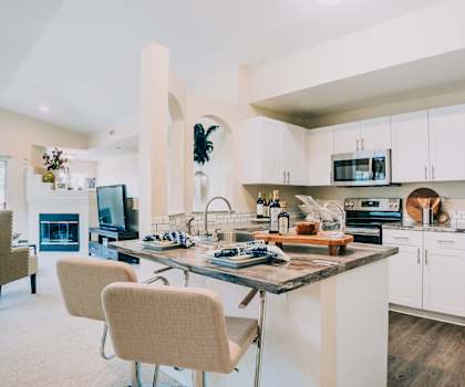 A modern kitchen with a large island and stainless steel appliances.