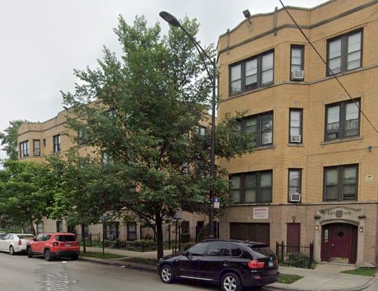 a black car is parked in front of a building