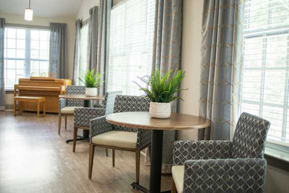 A dining room with a table and chairs.