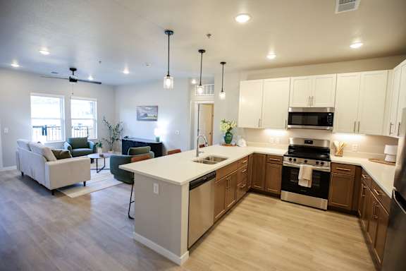 A modern kitchen with a white island and stainless steel appliances.