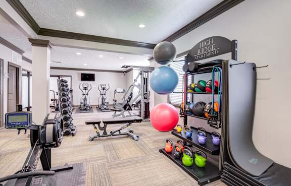 our apartments showcase a gym with equipment and a flat screen tv at High Ridge Apartments in Georgia, 30606