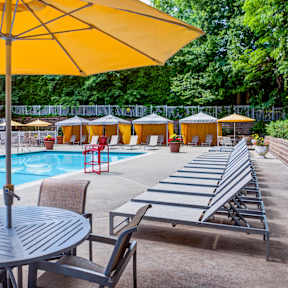 Pool surrounded by sun lounge chairs at The Henry, New York, 10970