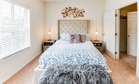 a bedroom with a bed and a window