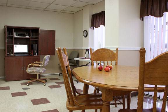 a dining room with a table and chairs