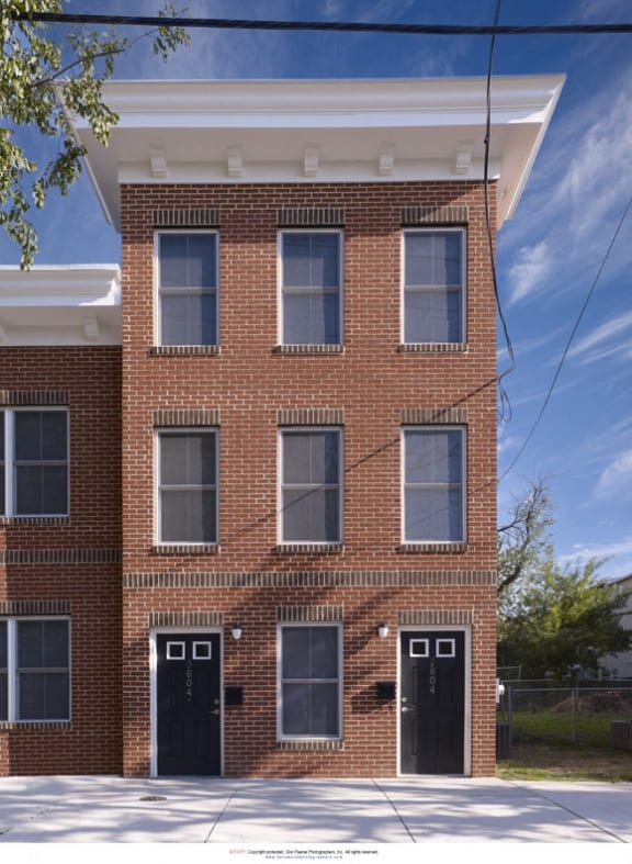a red brick building with black doors and windows