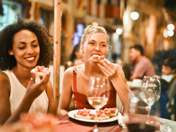 Two women enjoying a meal together at a restaurant.
