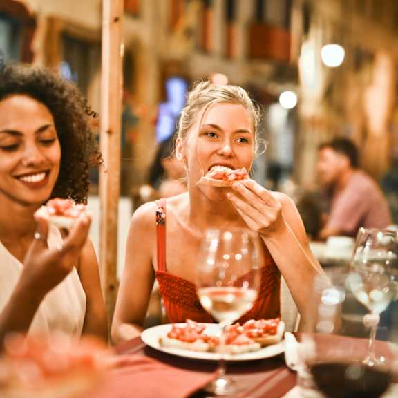 Two women enjoying a meal together at a restaurant.