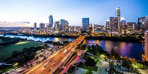 A cityscape with a river and a highway.