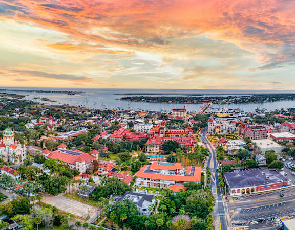 A beautiful aerial view of a town with buildings and a body of water in the distance.