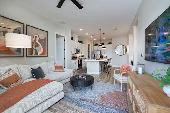A modern living room with a white sofa and a coffee table.