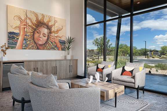 A living room with a large painting of a woman with sun in her hair.