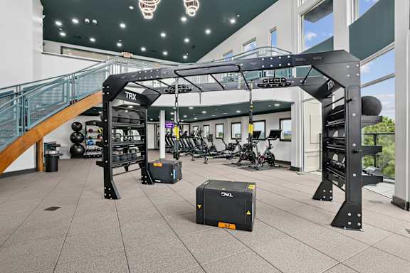 A gym with a TRX suspension trainer hanging from the ceiling.