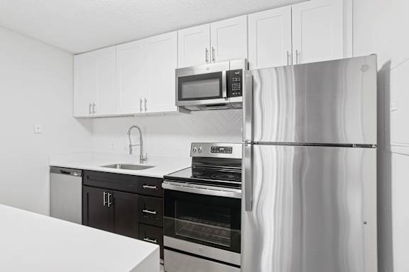 A modern kitchen with a stainless steel refrigerator.