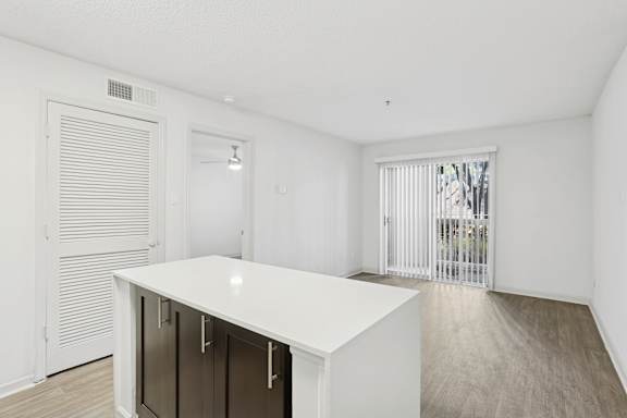 A white kitchen island with a black cabinet and a white countertop.