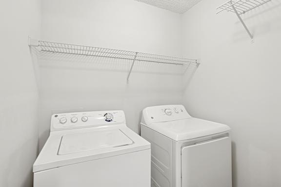 A white washing machine and dryer in a small laundry room.