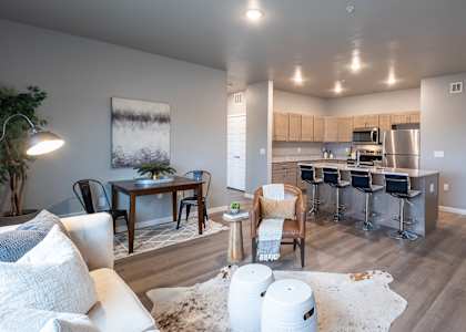 an open living room and kitchen with a dining room table and chairs at Technology Park, Rochester, MN