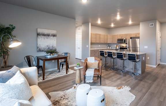 an open living room and kitchen with a dining room table and chairs