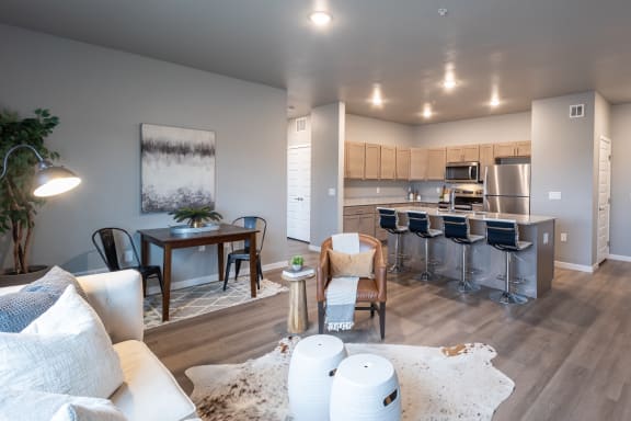 an open living room and kitchen with a dining room table and chairs