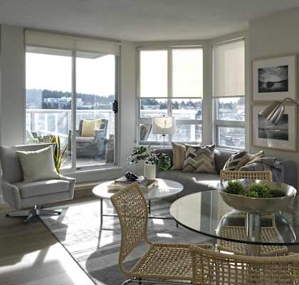 A modern living room with a glass table and chairs.
