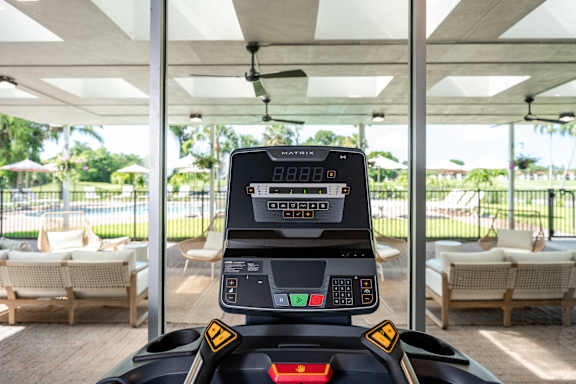 A control panel for a robotic lawnmower is shown with a digital display and several buttons.
