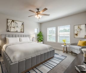 a bedroom with a large bed and a ceiling fan