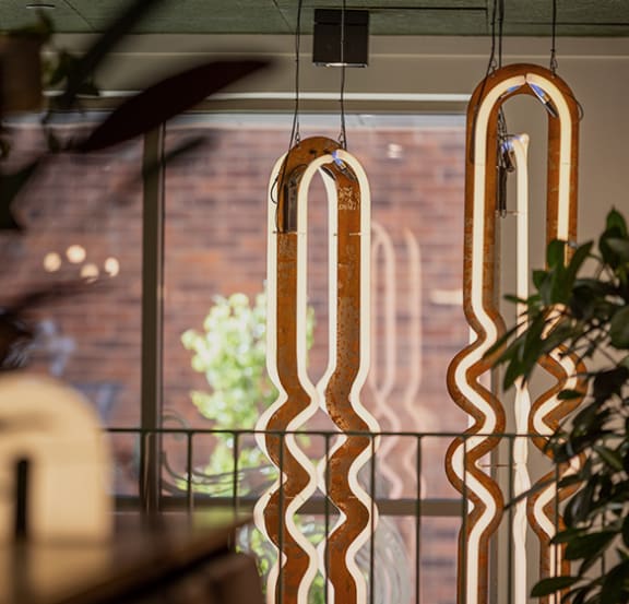 a pair of hanging glass windows with a view of a brick wall
