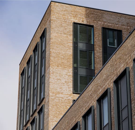 a pair of hanging glass windows with a view of a brick wall
