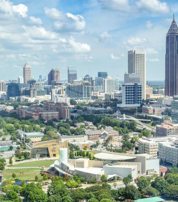 A cityscape with a mix of modern and older buildings, with a tall tower in the center at Northgate Townhomes in GA, 30084