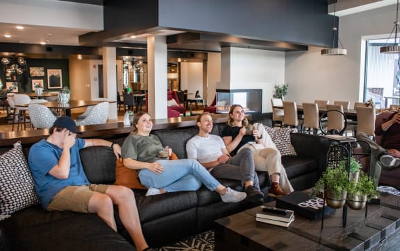a group of people sitting on a couch in a living room at Vue at Bluestone, Duluth, Minnesota