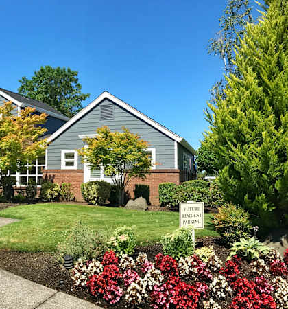 a house with a yard and a sign in front of it