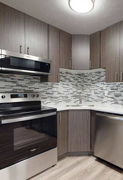 A kitchen with a stove, oven, and microwave.