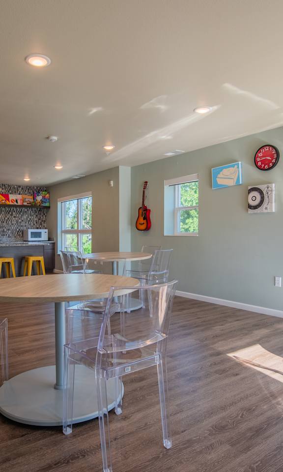 A dining room with a table and chairs.