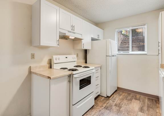 the preserve at ballantyne commons apartment kitchen with white appliances and white cabinets