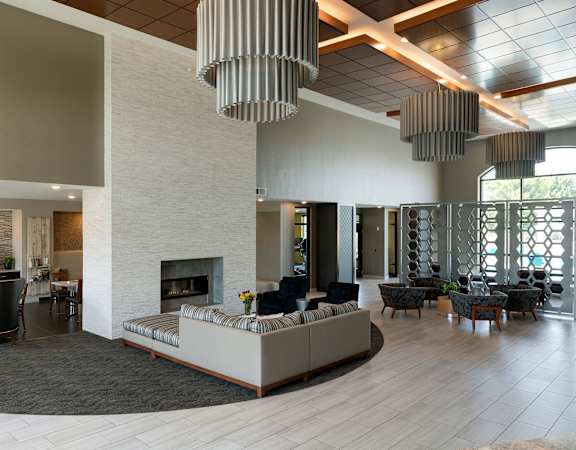 A modern living room with a fireplace and a large sofa.
