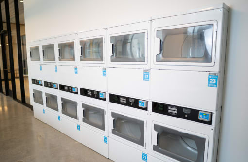 a row of microwaves on a wall in a room