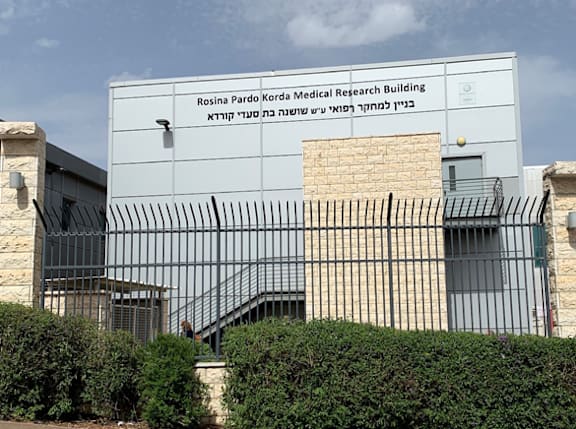 the front of a building with a fence