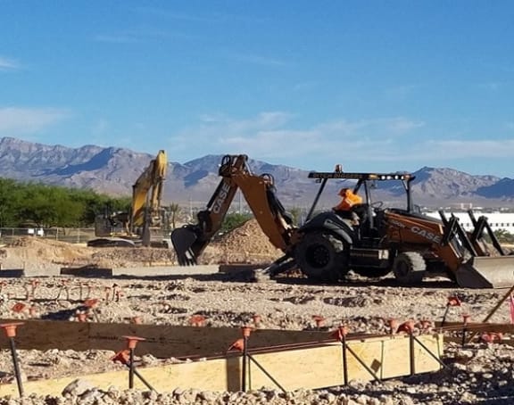 a man driving a bulldozer at a construction site