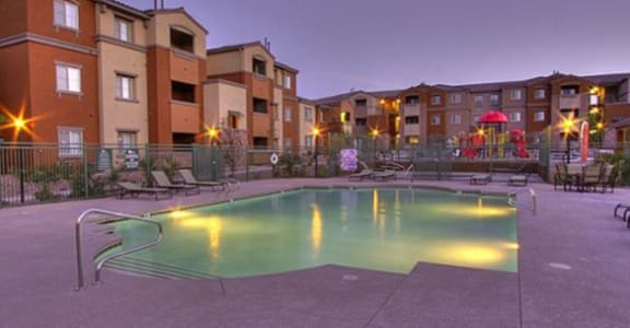 Evening view of Arbor Pointe's lighted community pool