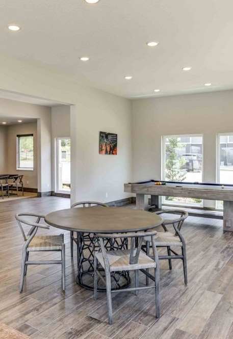 A room with a pool table and a television.