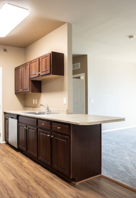 an empty living room with a kitchen in it