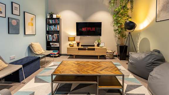 A living room with a Netflix sign on the wall.