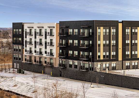 a rendering of an apartment building with a tennis court