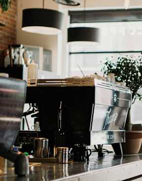 a coffee machine on a counter in front of a window