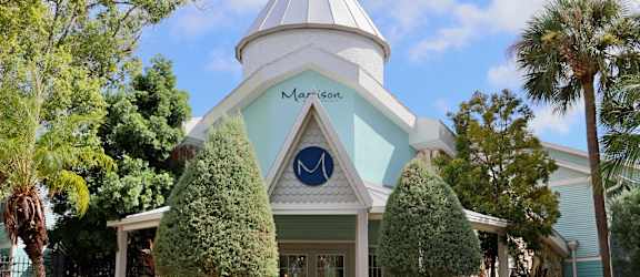 A white building with a blue roof and a sign that says "Marson".