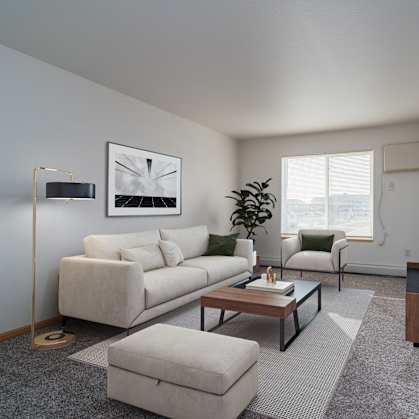 a living room with a white couch and a coffee table. Grand Forks Desoto Estates