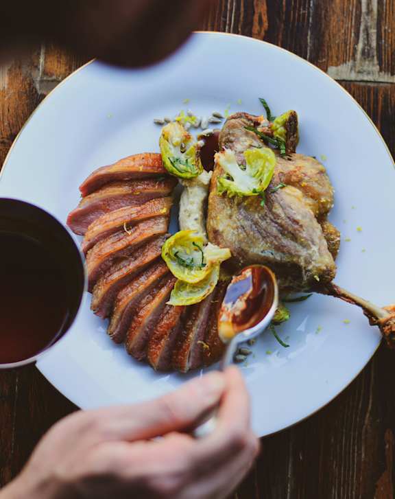 A person is eating a meal with a cup of tea.
