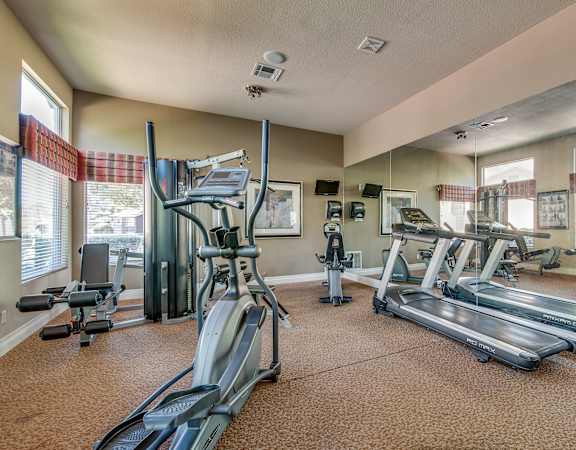 spacious gym with cardio equipment at the enclave at woodbridge apartments in sugar land