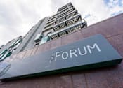 Thumbnail 1 of 3 - a sign for the forum in front of a tall building